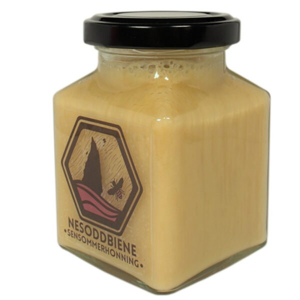 Image showing the late summer honey in a square jar from the side, where you get to see more of the square shape of the jar