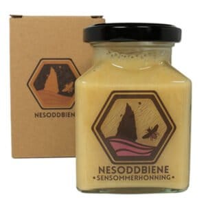 Jar of Late Summer Honey from Norwegian Fjords in a decorative square container, securely packaged in eco-friendly cardboard for safe shipping.