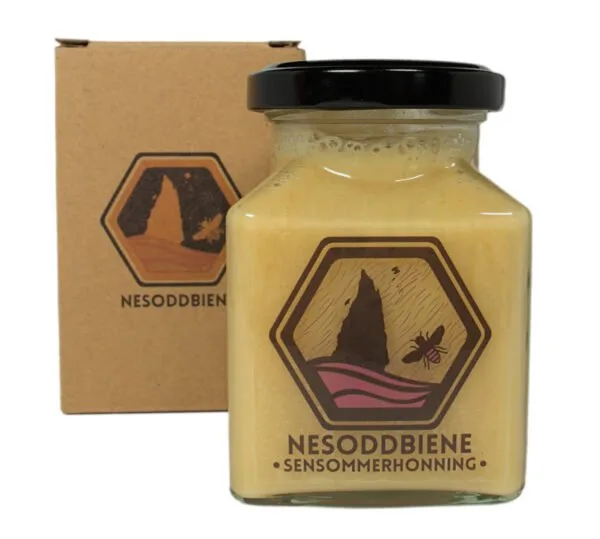 Jar of Late Summer Honey from Norwegian Fjords in a decorative square container, securely packaged in eco-friendly cardboard for safe shipping.